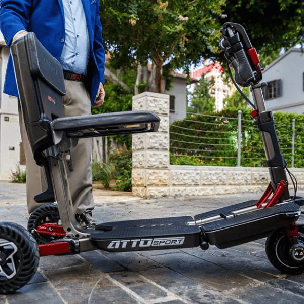 Man is standing with his ATTO SPORT mobility scooter