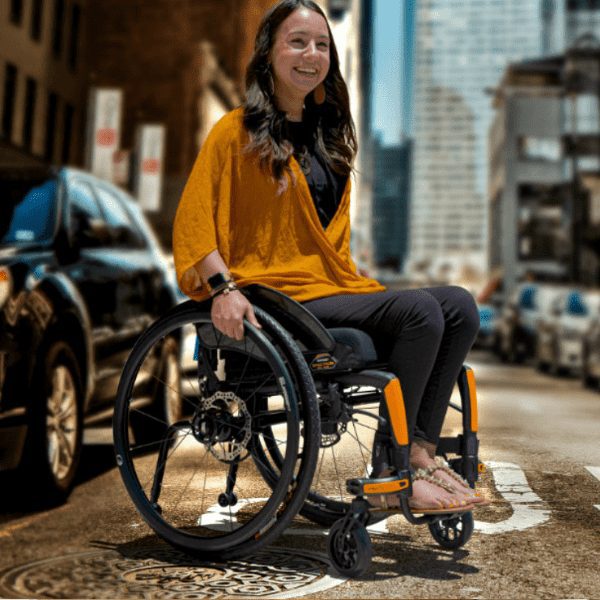 woman in yellow jumper in a wheelchair in the city