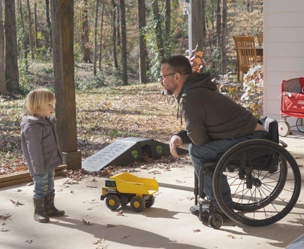 4 Man in wheelchair speaking to child