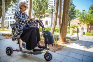 Elderly woman is using an ATTO Sport mobility scooter