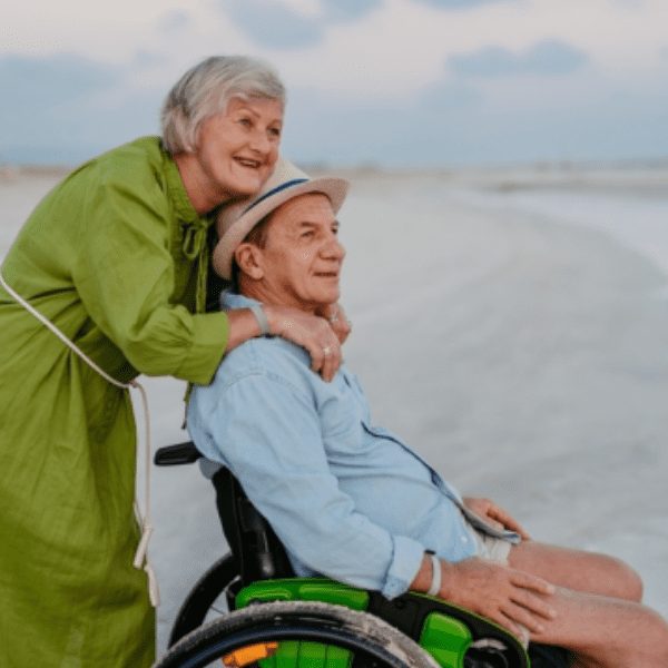 Senior man on wheelchair with his wife at sea
